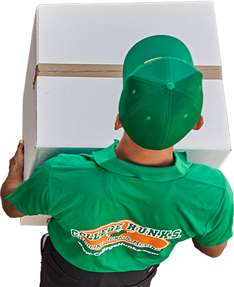 The back of a man holding a large box.
