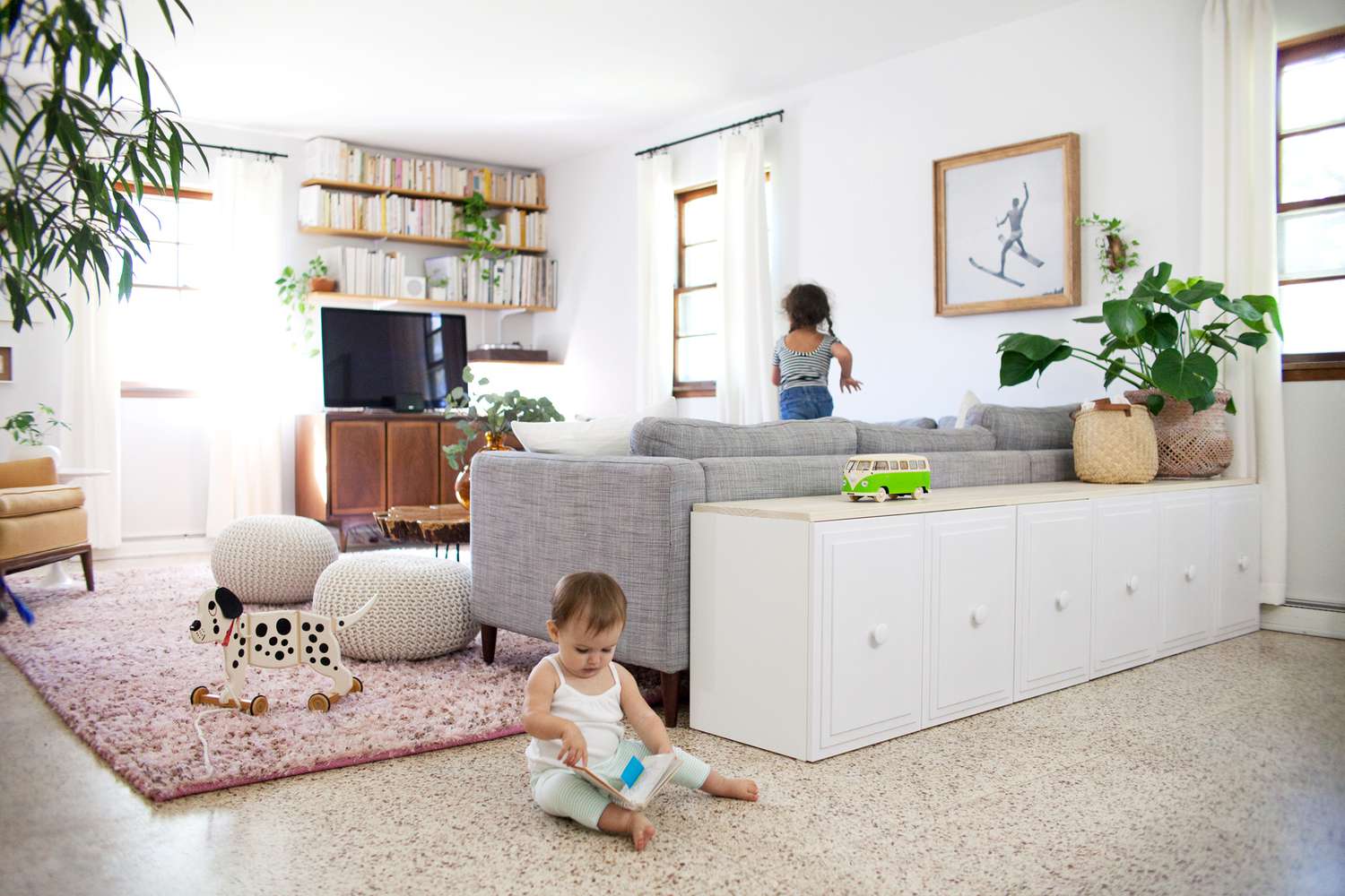 Living room with hidden toy storage and minimal clutter—a baby-proofing ideal.