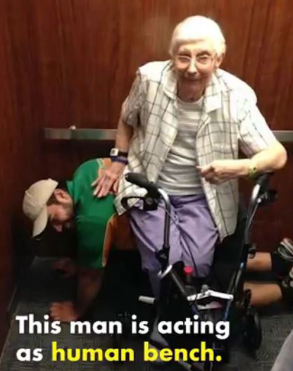 HUNK becomes a human bench for an elderly woman to sit on while stuck in an elevator.