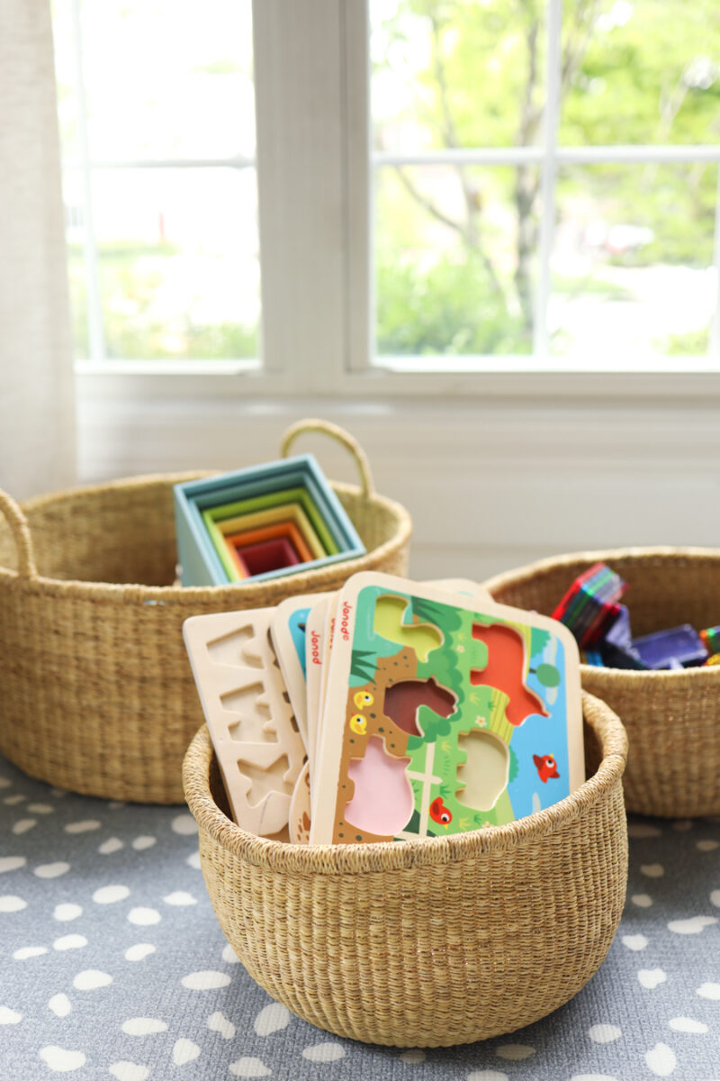 Labeled storage baskets with baby supplies and toys for a clutter-free home.