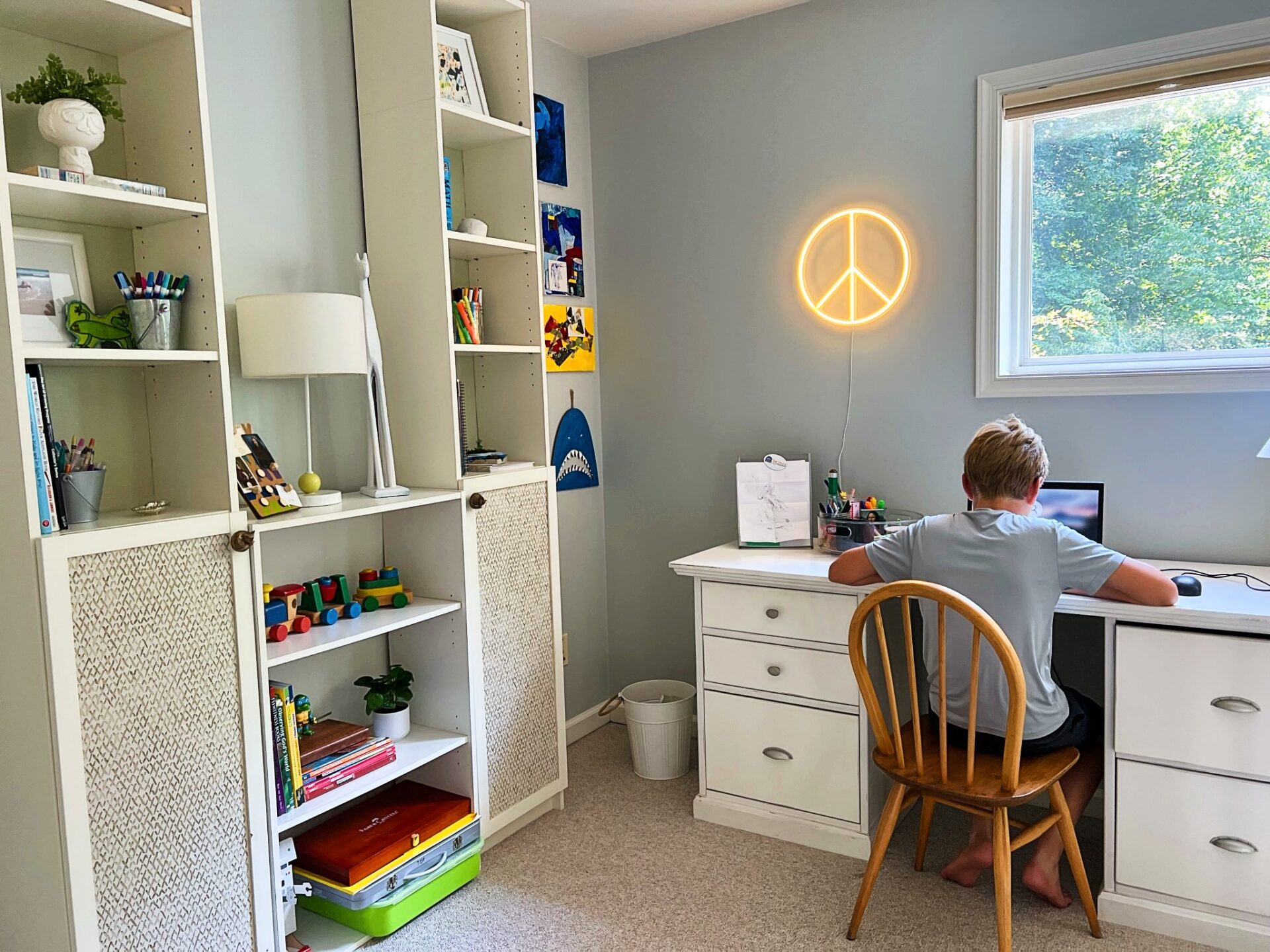 Bright homework corner with an integrated desk and shelves, neatly organized for school activities.
