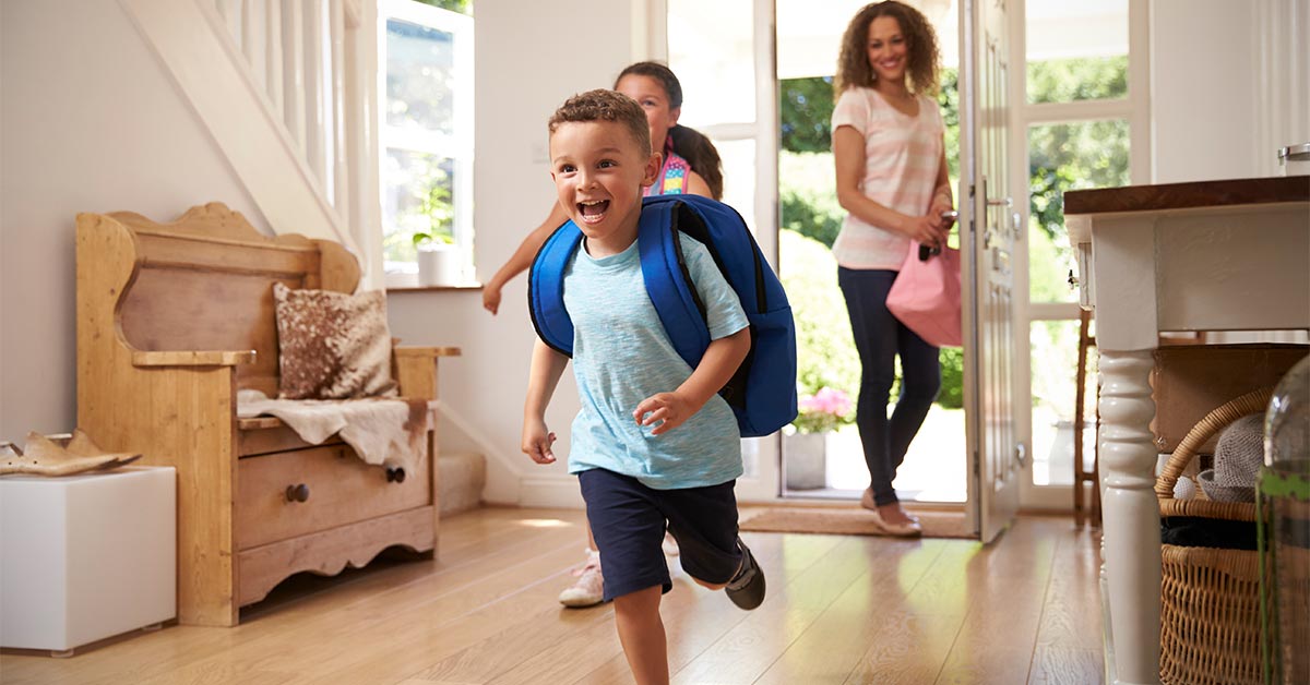  Children energetically moving through the home—conveys energy, activity, and managing household flow amid school bustle.