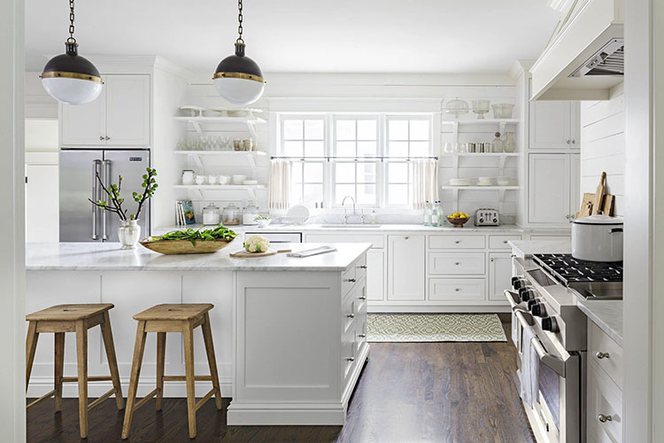 Bright white farmhouse kitchen utilizing open shelving