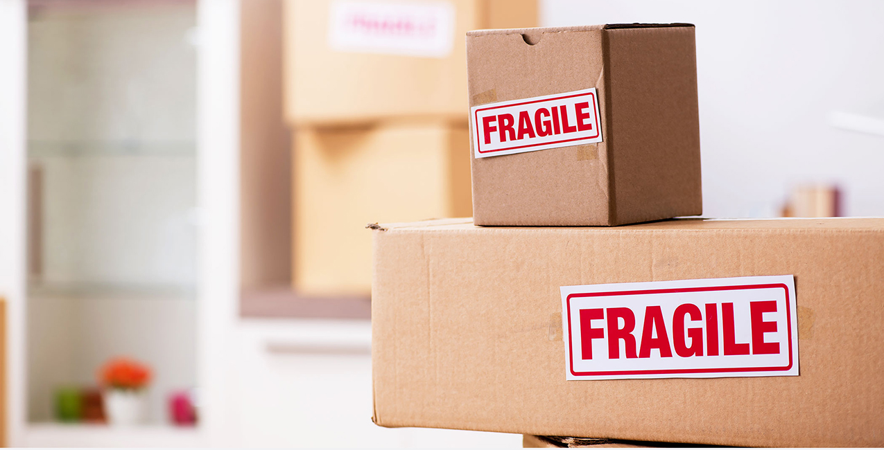 Cardboard boxes labeled “FRAGILE” ready for transport during a move