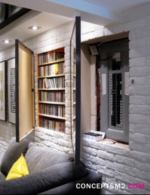Storage space hidden behind picture frames within a brick wall