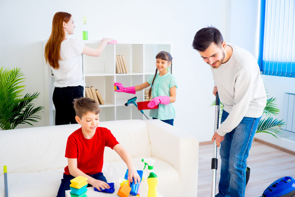 A parent and child working together in the kitchen, tidying up—reflects daily routines and teamwork.