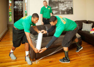 Our H.U.N.K.S. carefully wrapping furniture for protection during the move
