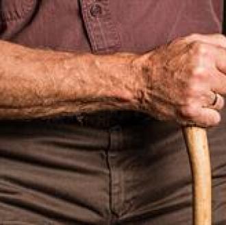 A hand holding a cane for safe support