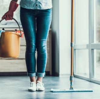 woman-holding-cleaning-supplies-in-bucket