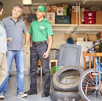 Homeowners looking at pile of junk to remove