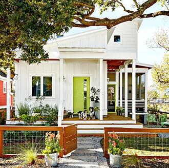 white home with green door has attractive curb appeal