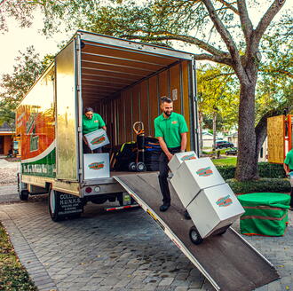 Professional movers loading boxes into a moving truck