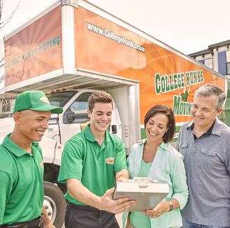 Happy family organizing their 8-week moving plan surrounded by moving boxes at home