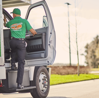 College HUNKS mover stepping into a moving truck while preparing for a customer’s move.