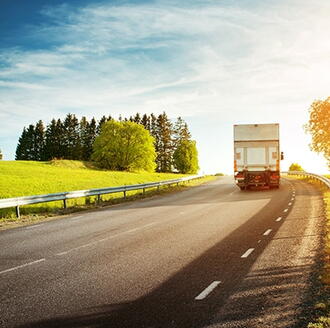 Cross-country moving truck traveling on a highway during a long distance relocation
