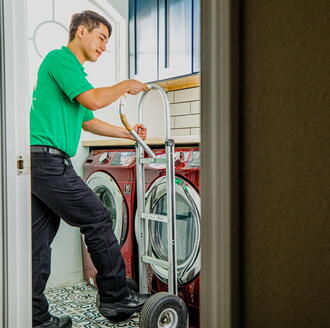 College Hunks mover taking out a washing machine