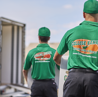 College Hunks movers walking towards a moving truck