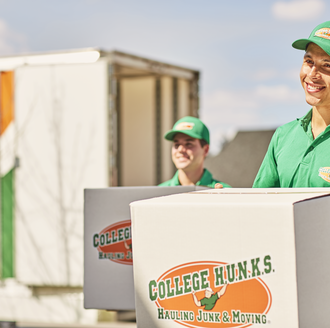 Two College Hunks movers with boxes