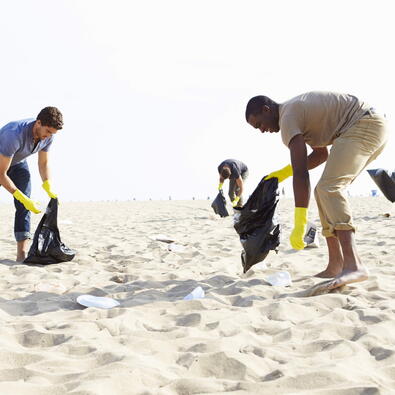 Community beach cleanup for National Clean Up Day with volunteers collecting waste