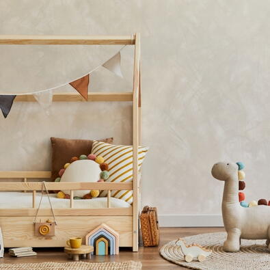 Low-to-the-ground Montessori-style toddler bed with safety rails and cozy bedding for smooth transition.