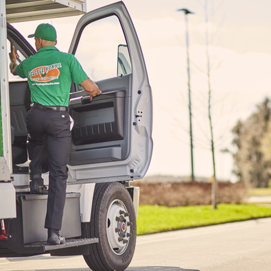 College HUNKS mover stepping into a moving truck while preparing for a customer’s move.