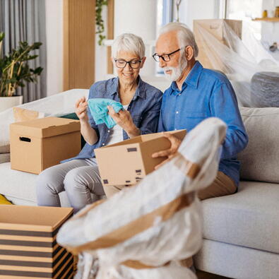 Seniors smiling in their new home after a successful move