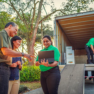 Home owners verifying information with College Hunks employee. 
