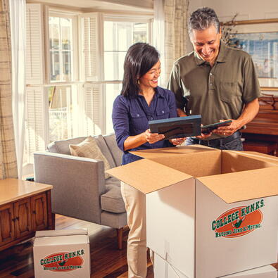 A couple opening a moving box.