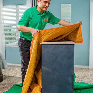 College Hunks employee wrapping furniture
