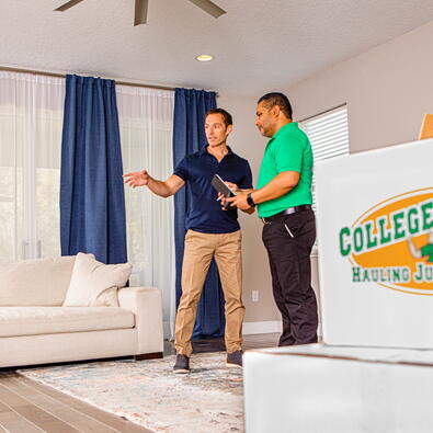 College Hunks employee with a client in a living room