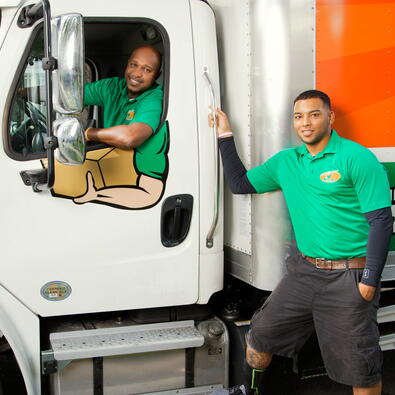 Two College Hunks employees outside a moving truck 