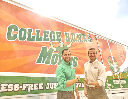 Founders Nick and Omar Standing Before a College Hunks Truck