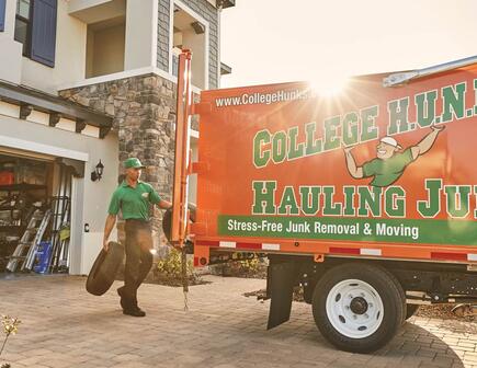 College Hunks team moving items into College Hunks truck