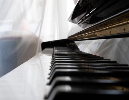 Close up of piano keys covered by plastic wrap