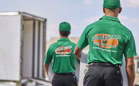 College Hunks movers walking towards a moving truck