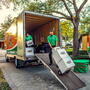 Professional movers loading boxes into a moving truck