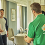 College Hunks movers and house owners in a conversation