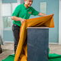 College Hunks employee wrapping furniture
