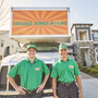 Two College Hunks haulers outside a moving truck