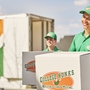 Two College Hunks movers with boxes